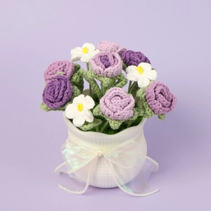 Handmade crochet rose potted plant with purple flowers and white daisies in a vase