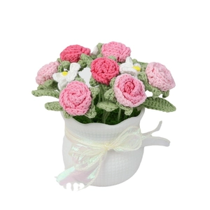 Handmade crochet pink and white roses in a white vase with iridescent ribbon bow