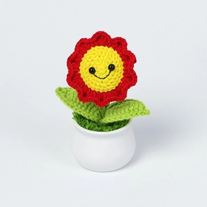 Detailed knit stitches and smiling face on handmade crochet sunflower plant