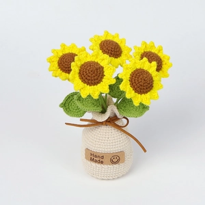 Close-up of handmade crochet sunflower pot with Hand Made leather label detail