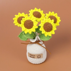 Handmade crocheted sunflower potted plant in a white knit vase for office desk decor