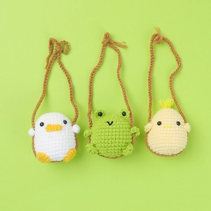 Handmade crochet animal car charms featuring cute duck, frog, and chick on swing