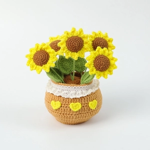Detailed knit texture of handmade crochet sunflower plant with lace pot and five blooms