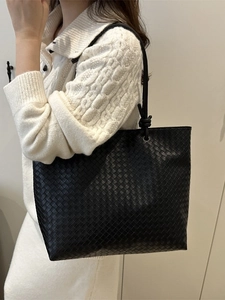 Minimalist black woven leather tote bag with large capacity for women's daily commute