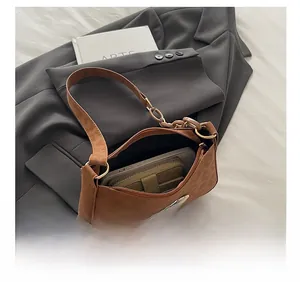 Brown suede underarm bag detail showing spacious interior for phone and wallet