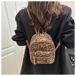 Detail view of mini leopard print plush backpack with adjustable brown leather straps