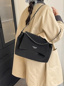 Chic black matte leather tote bag with silver chain strap for stylish daily commuting