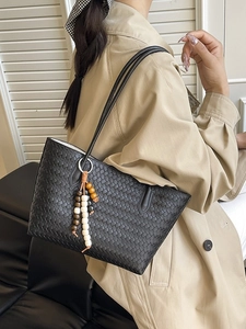 Black woven PU leather tote bag with wooden bead tassel charm for daily commute fashion