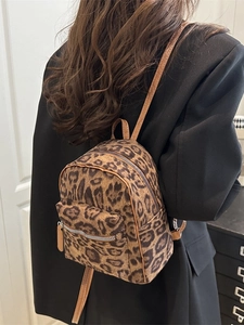 Fashionable leopard print mini backpack for women featuring silver zippers and brown straps