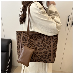 Detail of leopard print tote bag with matching lanyard coin purse and leather handles