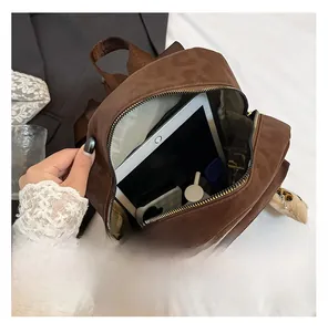 Top view of compact brown leopard backpack showing inner storage for tablet and phone