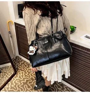 Detail of black faux leather tote bag with soft texture and stylish stitching design