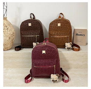 Detail view of leopard print backpacks in dark coffee, light brown and burgundy colors