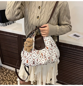 Detail of white bubble fabric tote bag with bear print and plush bear charm accessory