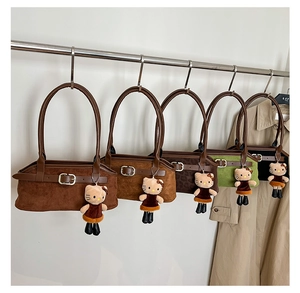 Suede shoulder bags in five colors with cute plush doll charms and metal buckle straps