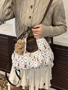 Quilted tote bag with animal pattern and brown leather handle on model