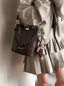 Retro dark brown bucket bag with woven handle and plush rabbit charm for women