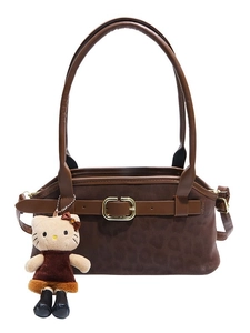 Dark brown matte handbag with gold buckle and cute plush kitty charm on white background