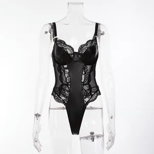 Detail view of black faux leather bodysuit featuring delicate lace patchwork and V-neckline