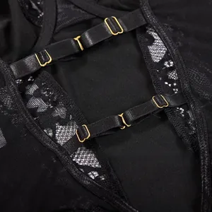 Detail of black lace bodysuit featuring gold metal buckles and adjustable elastic straps