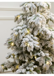Close-up of 135cm snowy PE Christmas tree with warm LED lights and thick flocked branches