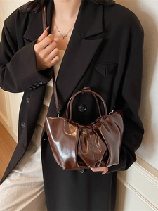 Brown ruched cloud handbag in shiny patent leather with a stylish shoulder strap
