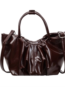 Dark brown pleated cloud bag in glossy PU leather with round handle and shoulder strap