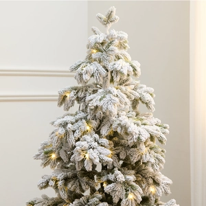 135cm snowy Christmas tree with warm LED lights in a stylish home interior setting