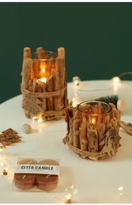 Macro view of rustic wooden candle holders with glass cups and premium tea lights set