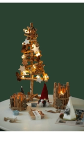 Detail of wooden Christmas tree with LED lights, rustic candle holders and a red gnome