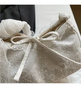Close-up of elegant cream lace embroidery and 3D floral details on the canvas tote bag