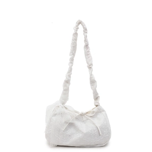 White lace tote bag with delicate embroidery and stylish bow decoration on a plain background