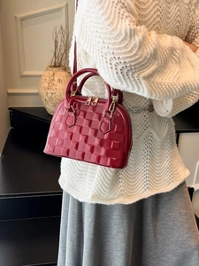 Deep red embossed crossbody handbag for women with textured woven pattern and gold zipper