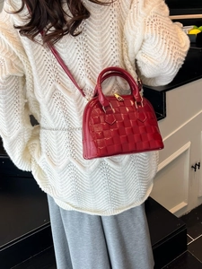 Red patent leather shell bag with embossed checkerboard pattern and gold hardware