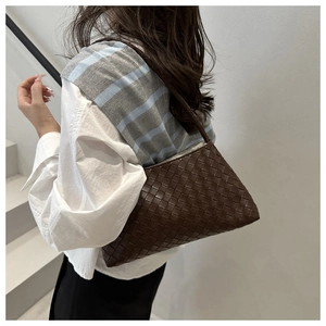 Detail of dark brown woven leather crossbody bag with Intrecciato texture for women