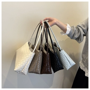 Detailed view of woven texture on minimalist square bags in five stylish color options