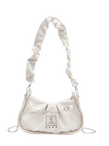 Creamy white ruched crossbody bag featuring pearl chain and bear patch detail