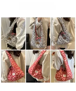 Detail shots of leopard print and pink heart canvas hobo tote bags with bow ties