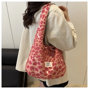 Detailed shoulder view of pink leopard print tote bag with soft fabric and wide straps