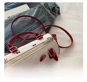 Detail of smooth silver metal zipper and red ruffle trim on a Boston handbag