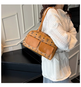 Detail of vintage brown shoulder bag with teddy bear print and double front pockets