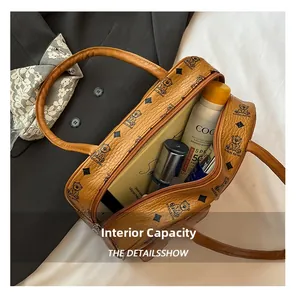 Macro view of open brown lychee leather boston bag with spacious interior capacity