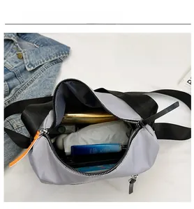 Detail view of the travel crossbody bag showing large capacity for umbrella and cosmetics