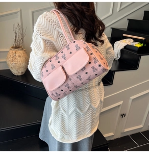 Detail of pink Boston bag with bear prints and functional double front pockets