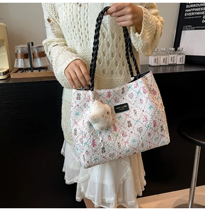 Close-up of floral tote bag with cute bear patterns and plush star charm detail