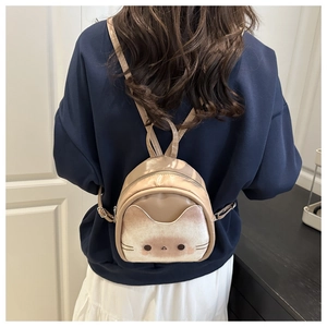 Detail view of mini cat backpack with cat ear design and adjustable straps on a model