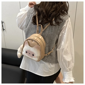 Detail of cute cat pattern backpack with adjustable straps and plush paw charm accessory