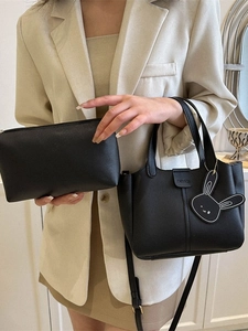 Black leather tote bag set with detachable shoulder strap and cute rabbit charm detail