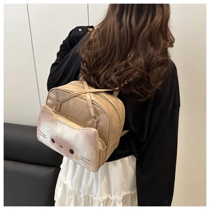Close-up of a model wearing a cute beige cat toast backpack with thin leather straps