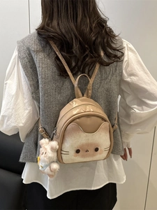 Cute beige mini backpack for women with cartoon cat print and plush rabbit charm